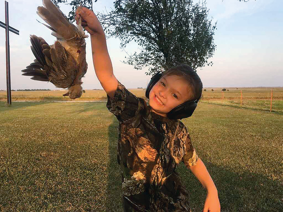 Nothing makes Wes smile more than getting his daughter involved in hunting and the outdoors. Here, she is shown with a dove they shot near their house.